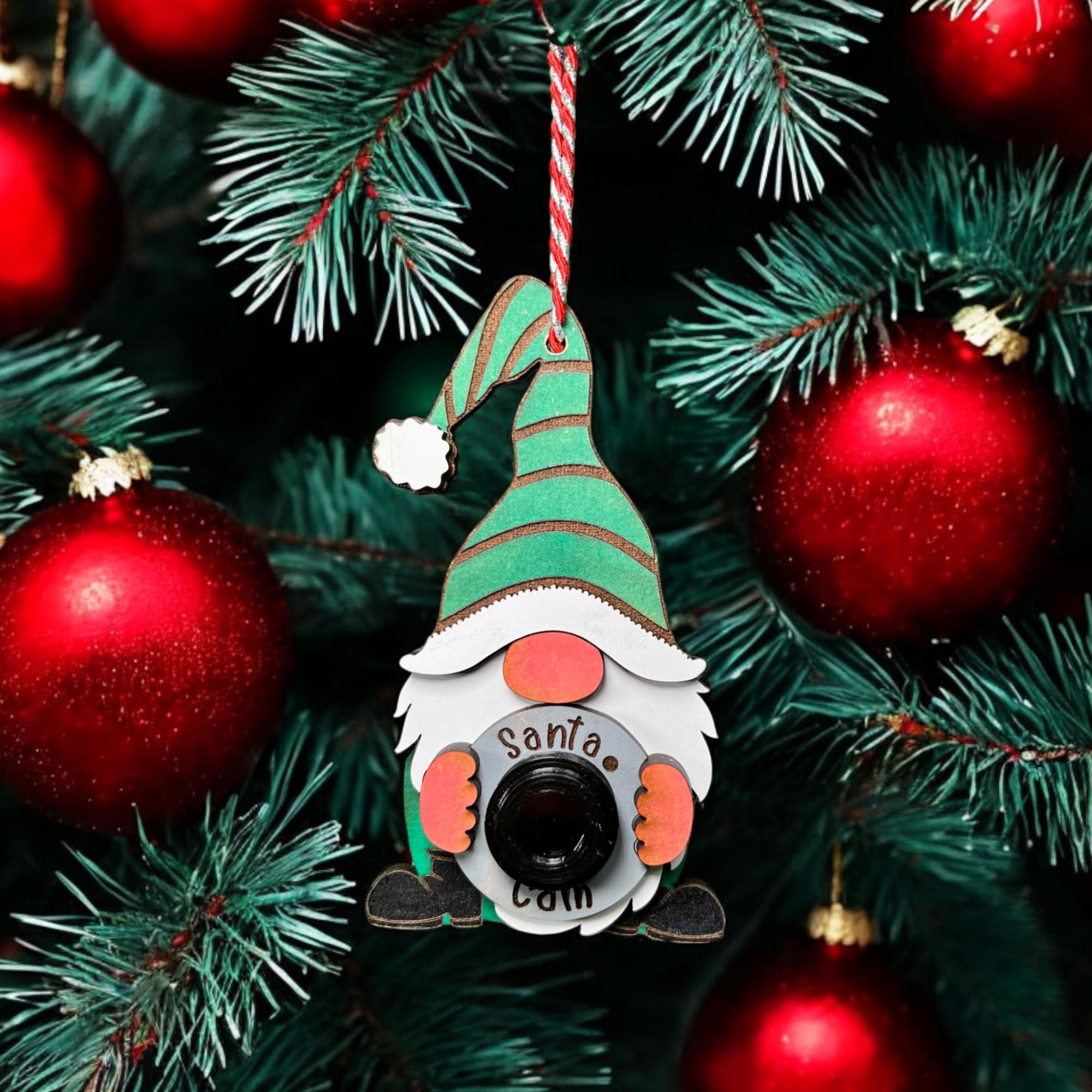 Close-up of a festive gnome holding a 'Santa Cam,' ideal for playful Christmas tree décor.